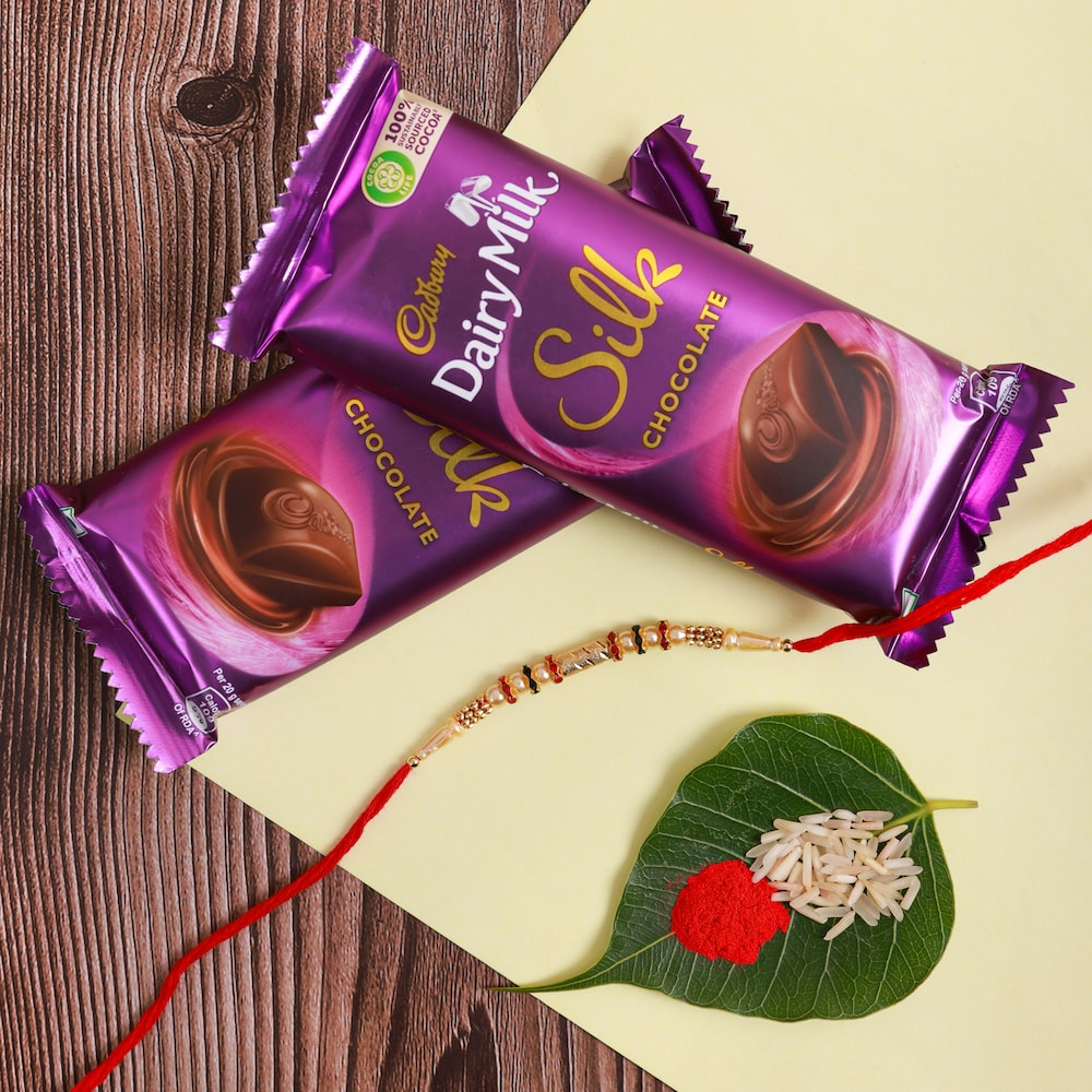  White Pearl Rakhi With Dairy Milk Silk Chocolate